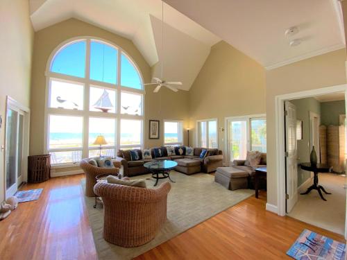a living room with a couch and chairs and a large window at Lookout Point in Edisto Island