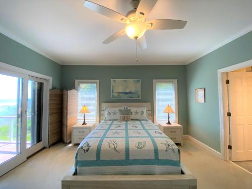 a bedroom with a bed and a ceiling fan at Lookout Point in Edisto Island