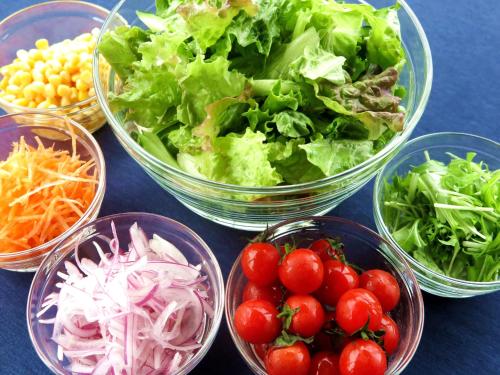 a group of bowls of vegetables and tomatoes on a table at Best Western Okinawa Onna Beach in Onna