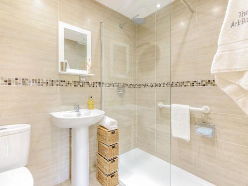 a bathroom with a toilet and a sink and a shower at The Ark Barn in Chillenden