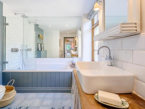 a bathroom with a large sink and a tub at The Barn in Shipton under Wychwood