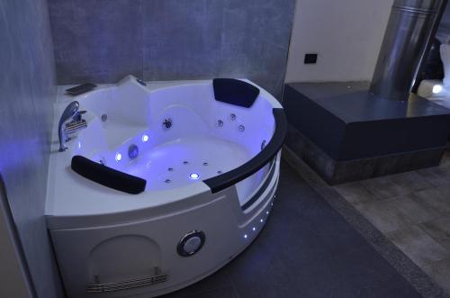 a bath tub in a bathroom with a sink at Hotel Seven Rooms in Milan