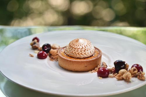 a dessert on a white plate on a table at Pensiunea Atra Doftana in Teşila