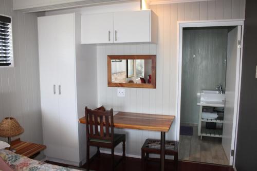 a small kitchen with a table and a sink at 14 Mount Joy in Knysna