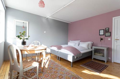 - une chambre avec un lit et une table ainsi qu'une salle à manger dans l'établissement Catogården - Boutique Home & Activity Centre, à Reine