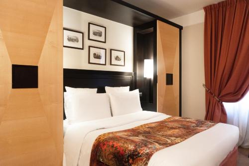 a bedroom with a large bed with a red curtain at Hôtel Régent Contades in Strasbourg