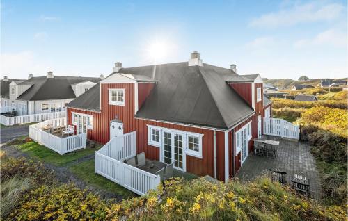 a red house with a black roof at Apartment Badevej X in Søndervig