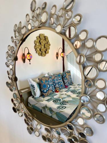 a mirror reflecting a bed in a bedroom at Gadea Boutique Hotel& Gadea Garden Italian Restaurant in Jambiani