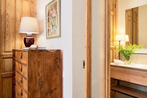 a room with a lamp on top of a wooden dresser at iloftmalaga Calle Álamos 23 in Málaga