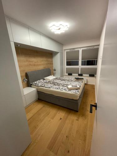 a bedroom with a bed in the middle of a room at Księżycowy Apartament Ursus in Warsaw