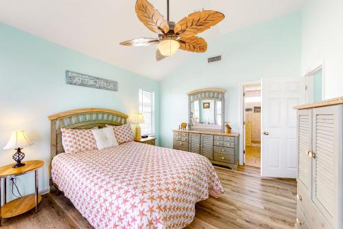 a bedroom with a bed and a ceiling fan at Sunset Beach in Dauphin Island