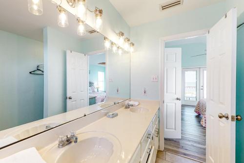 a bathroom with a sink and a mirror at Sunset Beach in Dauphin Island