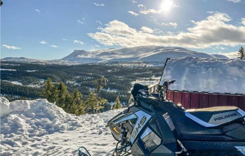a snowmobile parked on top of a snow covered mountain at Åreskutans Fjällstuga in Huså