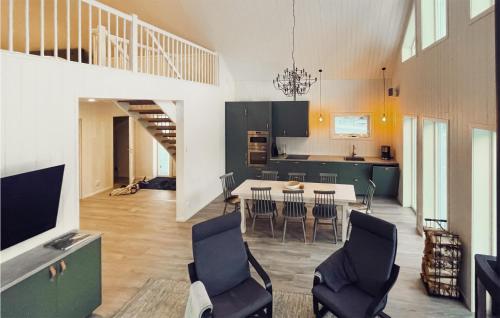 a kitchen and dining room with a table and chairs at Åreskutans Fjällstuga in Huså