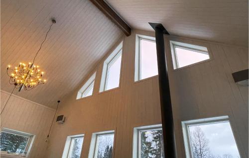 a chandelier is hanging in a room with windows at Åreskutans Fjällstuga in Huså