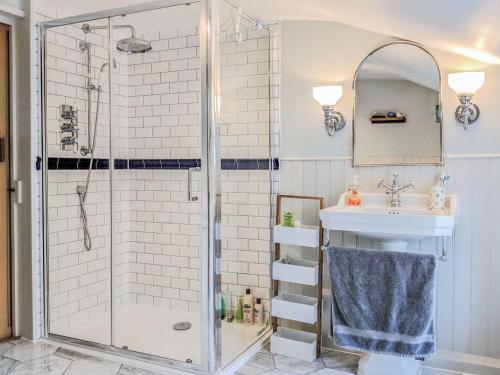 a bathroom with a shower and a sink at Teal Cottage in Honiton