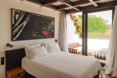 a bedroom with a bed and a large window at Casa Sua in Famara