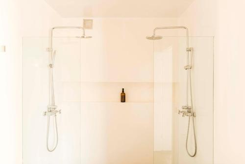 a bathroom with a shower with a glass door at Casa Sua in Famara