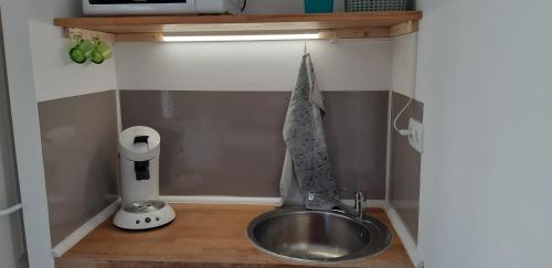 - un évier dans une petite cuisine avec un comptoir dans l'établissement petit studio indépendant dans jardin avec parking et portail électrique, à Marseille