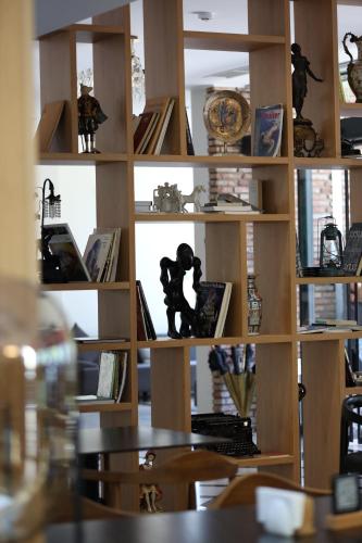 a book shelf filled with lots of books at Mukhrantubani Boutique Hotel in Tbilisi City