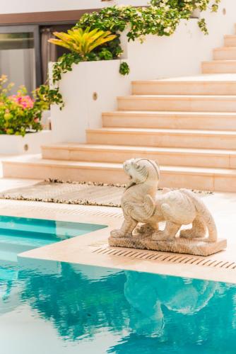 a statue of a sheep next to a swimming pool at Casa Sua in Famara