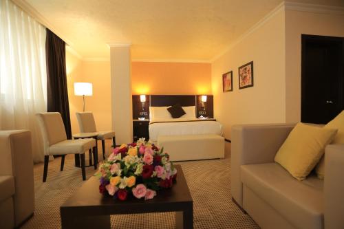 a hotel room with a bed and a living room at Cassiopeia Hotel in Addis Ababa