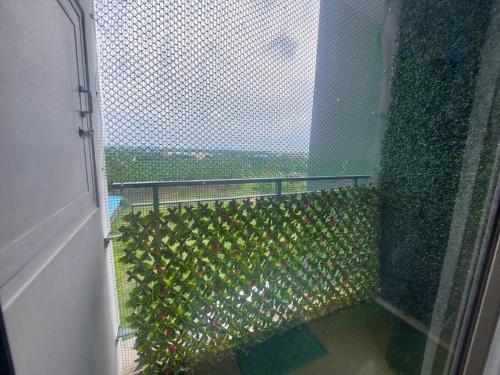 a balcony with a fence with plants on it at Lovely 1bedroom compact condo at 9th floor in Kelambākkam