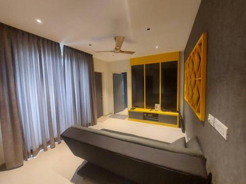 a living room with a bed and a window at Lovely 1bedroom compact condo at 9th floor in Kelambākkam