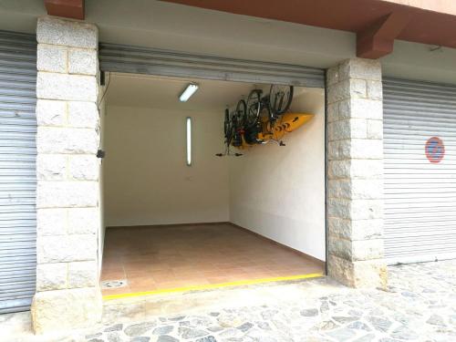 a garage with a bunch of bikes hanging on the wall at Noa Apartment En el corazón de los Pirineos in Adrall
