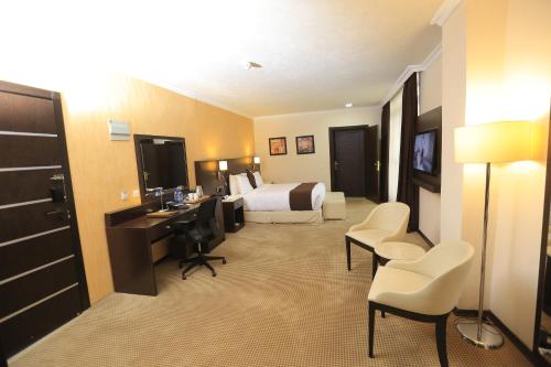 a hotel room with a bed and a desk at Cassiopeia Hotel in Addis Ababa