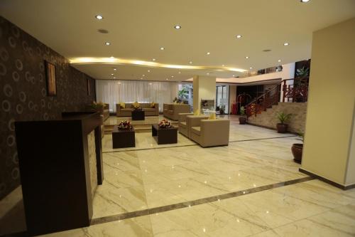 a lobby with couches and tables in a building at Cassiopeia Hotel in Addis Ababa