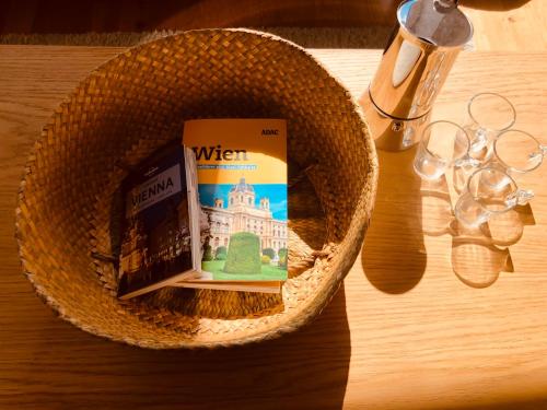 a basket with a book and glasses on a table at Helle 4 Zimmer Familien-Wohnung mit Balkon! Schloss Schönbrunn in Gehdistanz in Vienna