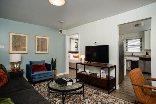 a living room with a couch and a tv at Abode Nashville - Marathon Village Near Downtown in Nashville
