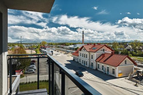 a view from a balcony of a building with a parking lot at ibis Styles Nowy Targ in Nowy Targ