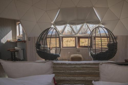 a room with two large metal spheres in a room at Domos by Toore Patagonia in Puerto Natales