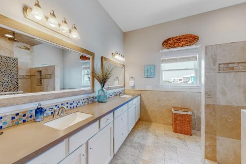 a bathroom with a sink and a mirror at Paradise Pointe in Port Aransas