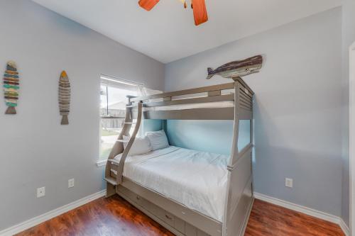 a bedroom with a bunk bed and a window at Paradise Pointe in Port Aransas