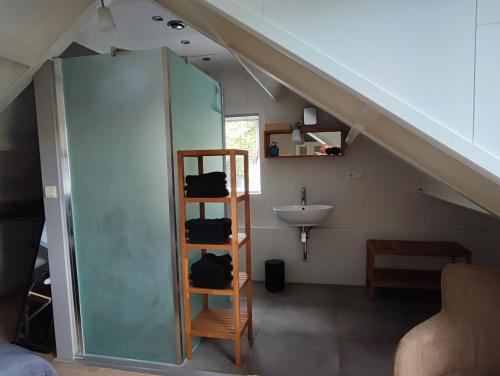 a bathroom with a sink and a staircase in a house at My Lodge in Dinteloord