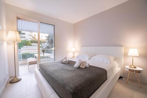 a bedroom with a large bed with two towels on it at Dream Apartment in Cannes