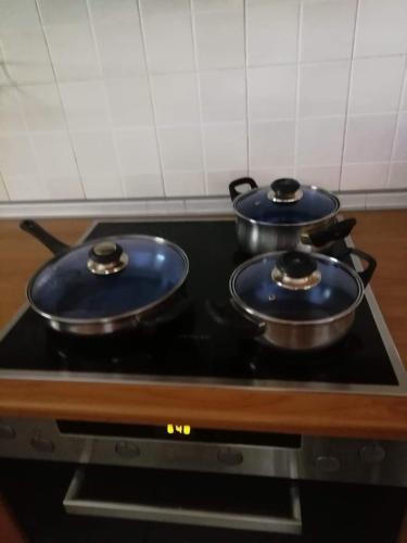 two pans sitting on top of a stove in a kitchen at Dellmar Apartment in Perea