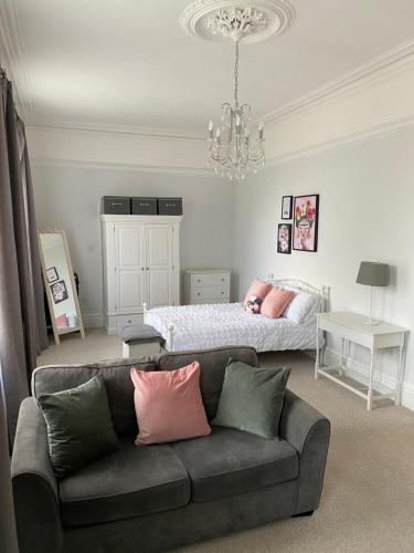 a living room with a couch and a bed at The Hole in the Wall, Midsomer Norton, Nr Bath & Longleat in Bath