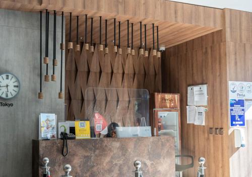 a store front with a clock on the wall at Hotel Perla Suite Santa Marta in Santa Marta