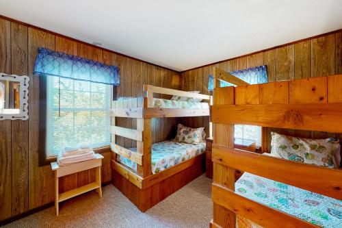 2 Etagenbetten in einem Zimmer mit Holzwänden in der Unterkunft Blue Dolphin 054 in Avon