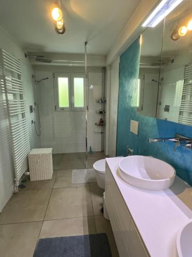 a bathroom with two sinks and a toilet and a shower at Casa Segnale in Ascona