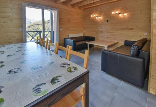 a kitchen and living room with a table and chairs at Domaine Du Sauveur in Luz-Saint-Sauveur