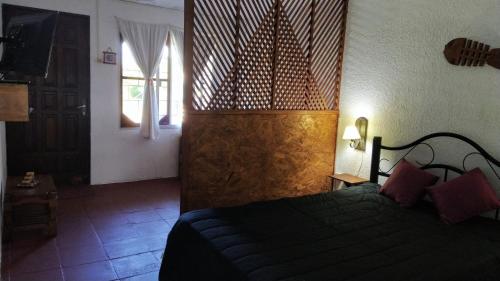 a bedroom with a bed and a television in a room at Kavok in La Paloma