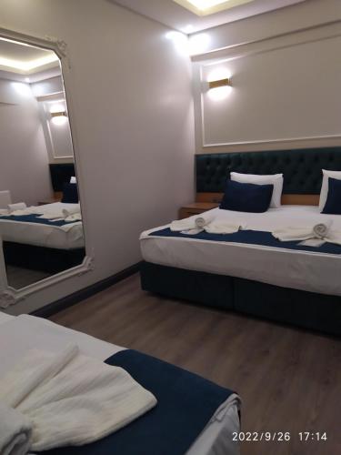 a bedroom with two beds and a large mirror at THE MOSS Hotel in Istanbul