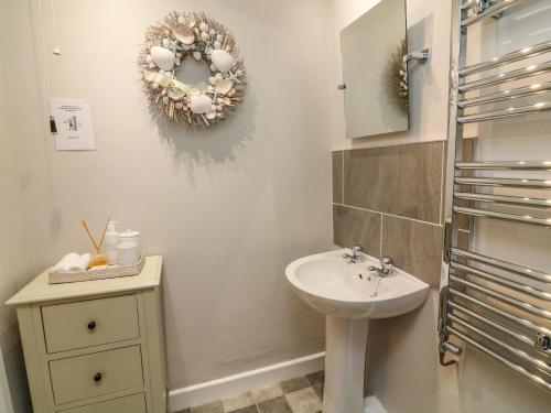 a bathroom with a sink and a mirror at Moor Cottage in Carnforth