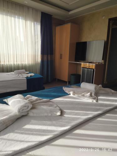 two beds in a hotel room with towels on them at THE MOSS Hotel in Istanbul