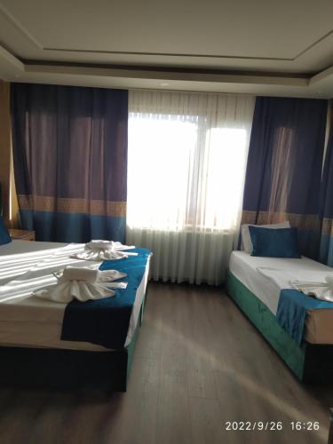 a bedroom with two beds and a window at THE MOSS Hotel in Istanbul